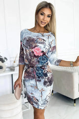 Numoco porty daydress with binding, 3/4 sleeves and pockets, flowers on a stone background  Adomoo